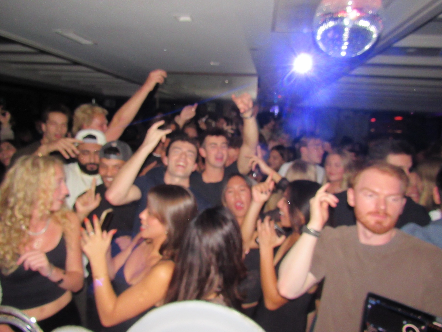 Crowd dancing together at a Panos set