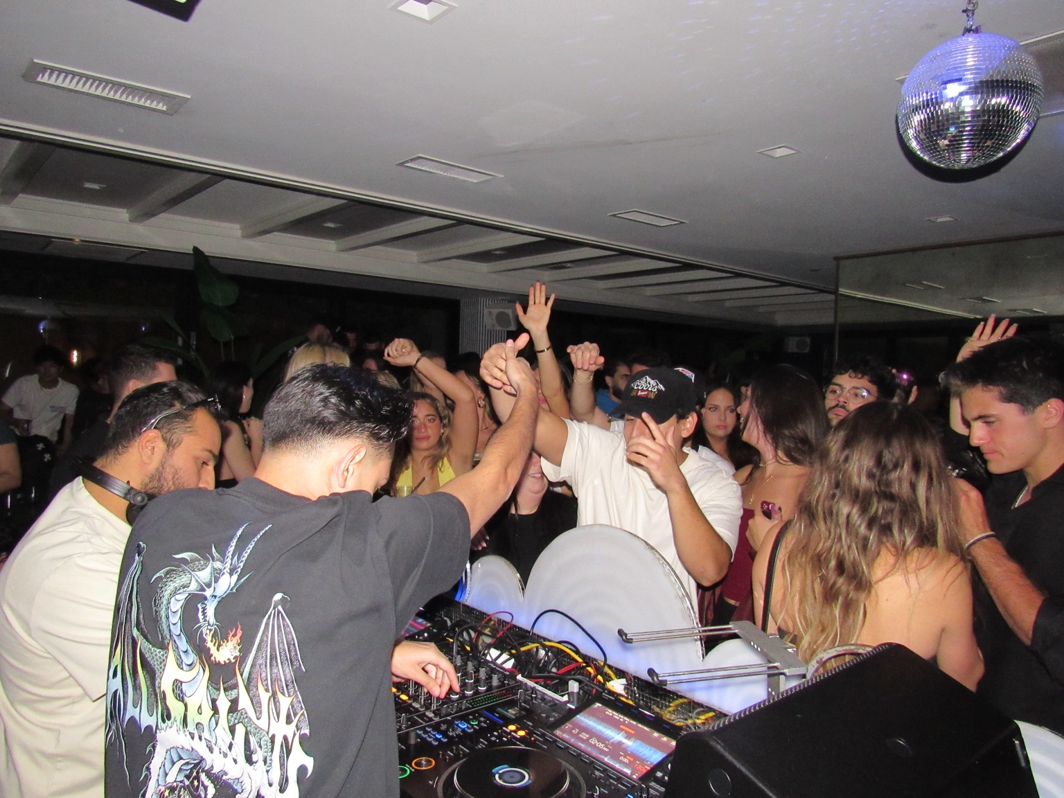 Dancers gathered around the DJ booth